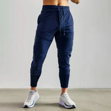 Marine blue lightweight men's tapered joggers in size 2XL, shown on a model, highlighting the fit around the waist and thighs. The joggers appear comfortable and suitable for athletic activities.