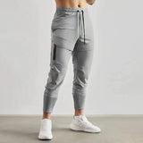 Gray men's tapered joggers in size 2XL, displayed on a model from waist to shoe, highlighting the lightweight fabric and athletic fit.