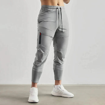 Gray men's tapered joggers in size 2XL, displayed on a model from waist to shoe, highlighting the lightweight fabric and athletic fit.