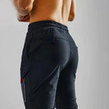 Gray men's tapered joggers, lightweight athletic sweatpants, displayed on a model highlighting the fit around the waist, knees, and thighs.
