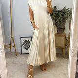 Gray pleated maxi dress with short sleeves, worn by a person accessorized with sunglasses, showcasing an elegant and versatile style.