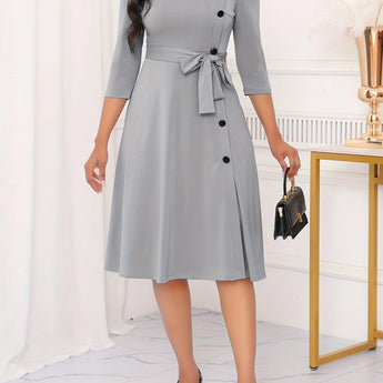 Gray plus-size midi dress with tie-waist and button-front, featuring a stylish design suitable for casual work settings, highlighting the dress's neckline, sleeves, and overall fit.