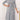 Gray plus size midi dress featuring a tie-waist and button-front design, suitable for casual work settings; includes long sleeves and a tailored fit for a flattering silhouette.