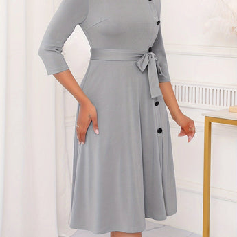 Gray plus size midi dress with tie-waist and button-front design, featuring long sleeves and tailored for a casual work setting.