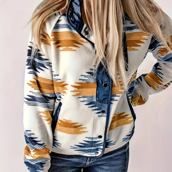 
A woman wearing a stylish winter outerwear in the form of a green Aztec print zip-up bomber jacket. She pairs the jacket with jeans and has a casual hairstyle. The jacket features long sleeves and is designed for comfort and warmth. The variant shown is in blue and size 2XL.