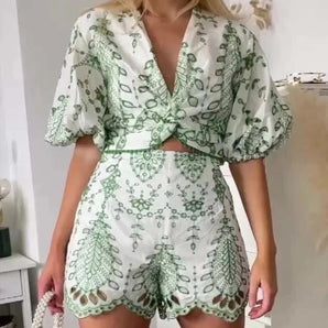 Green botanical print V-neck wrap dress and high waist shorts set, featuring a stylish one-piece garment showcasing a vibrant pattern, designed with a flattering wrap style and short sleeves.