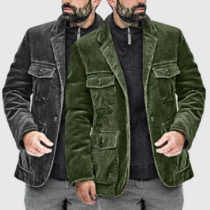 Green corduroy trucker jacket for men featuring a velvet collar, displayed in a photograph highlighting the clothing's details, such as the black textile collar, sleeves, and overall outerwear design.