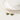 Gold hoop earrings with green crystal accents, designed by YA-CHAN, displayed against a minimalistic background.