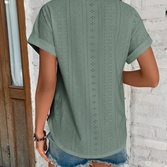 Green eyelet short sleeve blouse featuring laser cut design, breathable fabric, trendy fashion style, displayed on a mannequin with focus on shoulder and sleeve details.