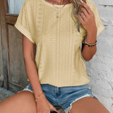 Green eyelet short sleeve blouse with laser cut design, shown on a model wearing denim shorts, highlighting the shoulder, neck, and waist areas.