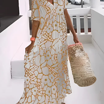 Green floral bohemian maxi dress with pockets, featuring a V-neck design and suitable for resort wear. The dress showcases long sleeves and a flowing silhouette, ideal for a fashionable and comfortable day look.