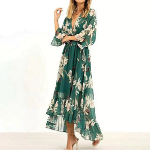 Green floral bohemian maxi dress with long sleeves and a chiffon wrap style, featuring a V-neckline and cinched waist.
