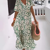 Green floral bohemian maxi dress featuring a V-neck and pockets, designed as resort wear. The dress is shown in a Verde1 color variant and 3XL size, highlighting the one-piece garment style with attention to the shoulder, sleeve, waist, and neck areas.