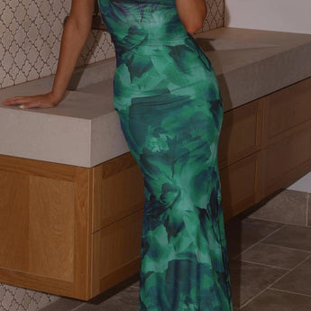 Green floral satin maxi dress with an open back design, featuring a strapless style and flowing silhouette, perfect for summer occasions.
