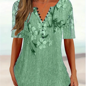 Green floral V-neck blouse with pleated short sleeves, designed as a summer top, featuring a stylish and fashionable look.
