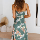 
A green floral wrap midi dress featuring a V-neck and sleeveless design, ideal for spring fashion.