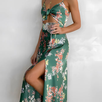 Green floral wrap midi dress with a V-neck and sleeveless design, perfect for spring fashion, featuring a fitted waist and flowing skirt.