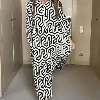 
A woman wearing a green geometric long sleeve midi dress, showcasing fall fashion. The dress features a fitted waist and a stylish design, highlighting the sleeves and neckline.