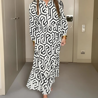 
A woman wearing a black long sleeve midi dress with a geometric design, featuring a fitted waist and a high collar, showcasing fall fashion for women.