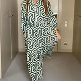 
A green geometric long sleeve midi dress for women, showcasing fall fashion with a knee-length design.