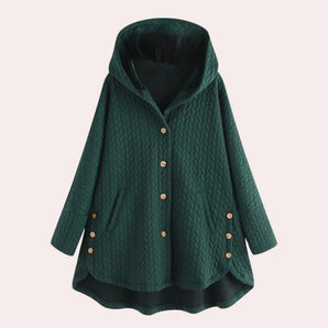 
A light green plus size women's quilted cape with a hood, featuring a button-up front and long sleeves.