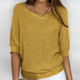 
A woman wearing a casual lightweight spring top in yellow, featuring a knit design with long sleeves, a crew neck, and a relaxed fit suitable for plus sizes.