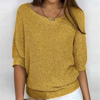 
A woman wearing a casual lightweight spring top in yellow, featuring a knit design with long sleeves, a crew neck, and a relaxed fit suitable for plus sizes.