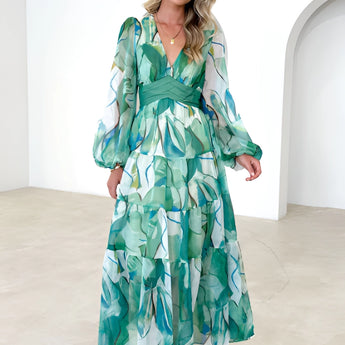 Green Leaf Print Chiffon Maxi Dress with V-neck and long sleeves, featuring a flattering waistline and elegant design, suitable for summer wear. The dress is styled as a one-piece garment, available in a size 5XL, showcasing a fashionable and formal look.