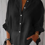 A black women's relaxed fit button-down blouse made of linen, featuring long sleeves and a classic collar.