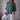 Women's relaxed fit button-down blouse in dark green linen, featuring long sleeves, a structured collar, and button details, displayed on a mannequin.