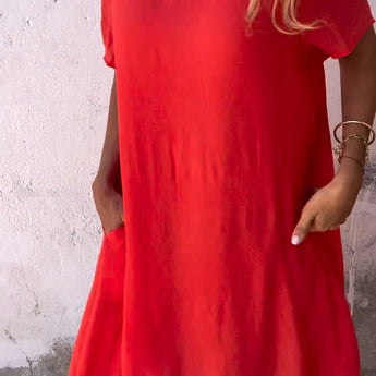 A red, oversized linen tunic dress designed for casual summer wear, featuring a breathable fabric, short sleeves, and a stylish yet comfortable fit.