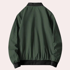 Men's green lightweight bomber jacket with urban style, featuring long sleeves, a wind-resistant design, and functional pockets.
