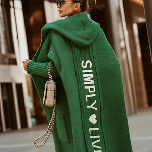 Green oversized knitted cardigan for women in 3XL, featuring a stylish winter fashion design with a cozy, loose fit. The cardigan is paired with a t-shirt underneath, and the model showcases an elegant, casual look.
