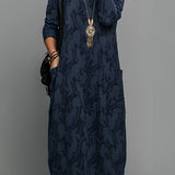 Blue long sleeve midi dress featuring a tribal necklace, highlighted by its patterned design, suitable for daytime wear.