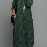 Green patterned long sleeve midi dress in size 3XL featuring a tribal necklace, showcasing its one-piece design with a fitted waist and comfortable sleeves.