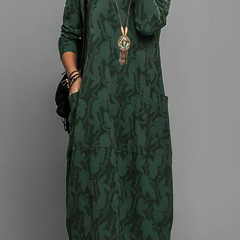 Green patterned long sleeve midi dress in size 3XL featuring a tribal necklace, showcasing its one-piece design with a fitted waist and comfortable sleeves.