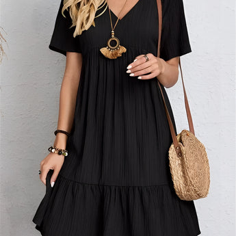 
A woman wearing a green pleated midi dress with short sleeves, suitable for summer casual wear. The dress is styled in a Nero color option and is available in size 3XL.