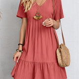 A red pleated midi dress in size 3XL with short sleeves, featuring a fitted waist and a round neckline. The dress is designed for summer casual wear and is shown on a standing model.