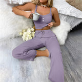 Woman wearing a purple ribbed lace trim jumpsuit, standing with hand on hip, showcasing comfortable loungewear.