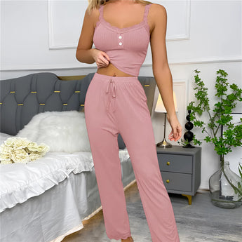 Woman wearing a green ribbed lace trim jumpsuit with long sleeves and a comfortable fit, standing in a neutral background.
