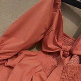 A green smocked dress for women featuring a ruched square neckline, perfect for spring wear.