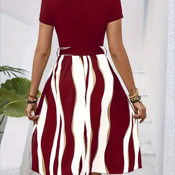 A casual summer short sleeve dress with green stripes, belted at the waist, featuring a flared design.