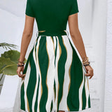 A casual summer dress with green stripes, short sleeves, a belted waist, and a flared skirt.