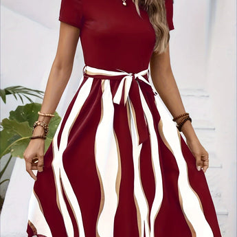 A casual summer green striped belted flare dress with short sleeves, showcasing a fitted waist and flared skirt.