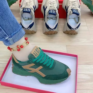 Green suede sneakers with a gold star design, featuring a white sole and light blue accents, designed for fashion-conscious individuals; available in size 40.