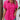 A woman wearing a pink rose short sleeve cotton blouse with pleated back detail, visible from the shoulders down to the arms.