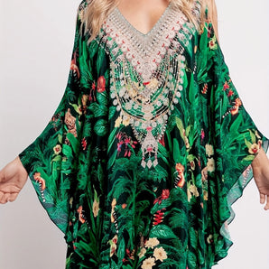 Green tropical kaftan with floral print, featuring a loose fit and luxurious design, ideal for beachwear.