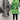 Green tropical print women's designer statement jacket featuring chic lightweight material, showcasing vibrant patterns and a stylish design with a focus on fashion detailing like structured shoulders, defined neckline, and tailored sleeves.
