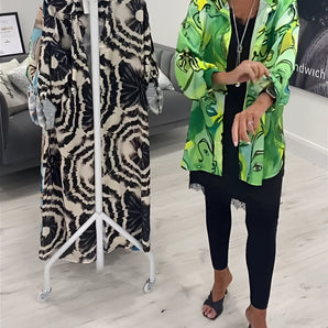 Green tropical print women's designer statement jacket, lightweight with chic fashion appeal, featuring a vibrant pattern and tailored for a stylish fit.