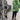 Women's designer statement jacket featuring a green tropical print, showcasing lightweight and chic style with detailed sleeves and a fashionable neckline.